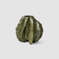A small sculptural vase with a ribbed, organic shape and a textured olive-green glaze, photographed against a clean light gray background.