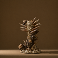 A decorative candle holder made from clustered seashells and spiral shell spires, displayed on a round base against a warm brown studio background.