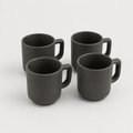 Four black mugs on a white background