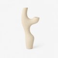 Beige ceramic vase with abstract design on a white background