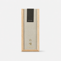 A tall rectangular incense box with a light natural wood frame and a cream-colored lid featuring a subtle circular pattern, a black label near the top reading 'hitotoki', and gold text near the bottom reading 'Sandalwood', shown on a clean white background.