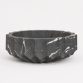 Black marble bowl with a faceted design on a white background