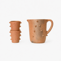 Set of terracotta ceramic pots with textured surface on a white background