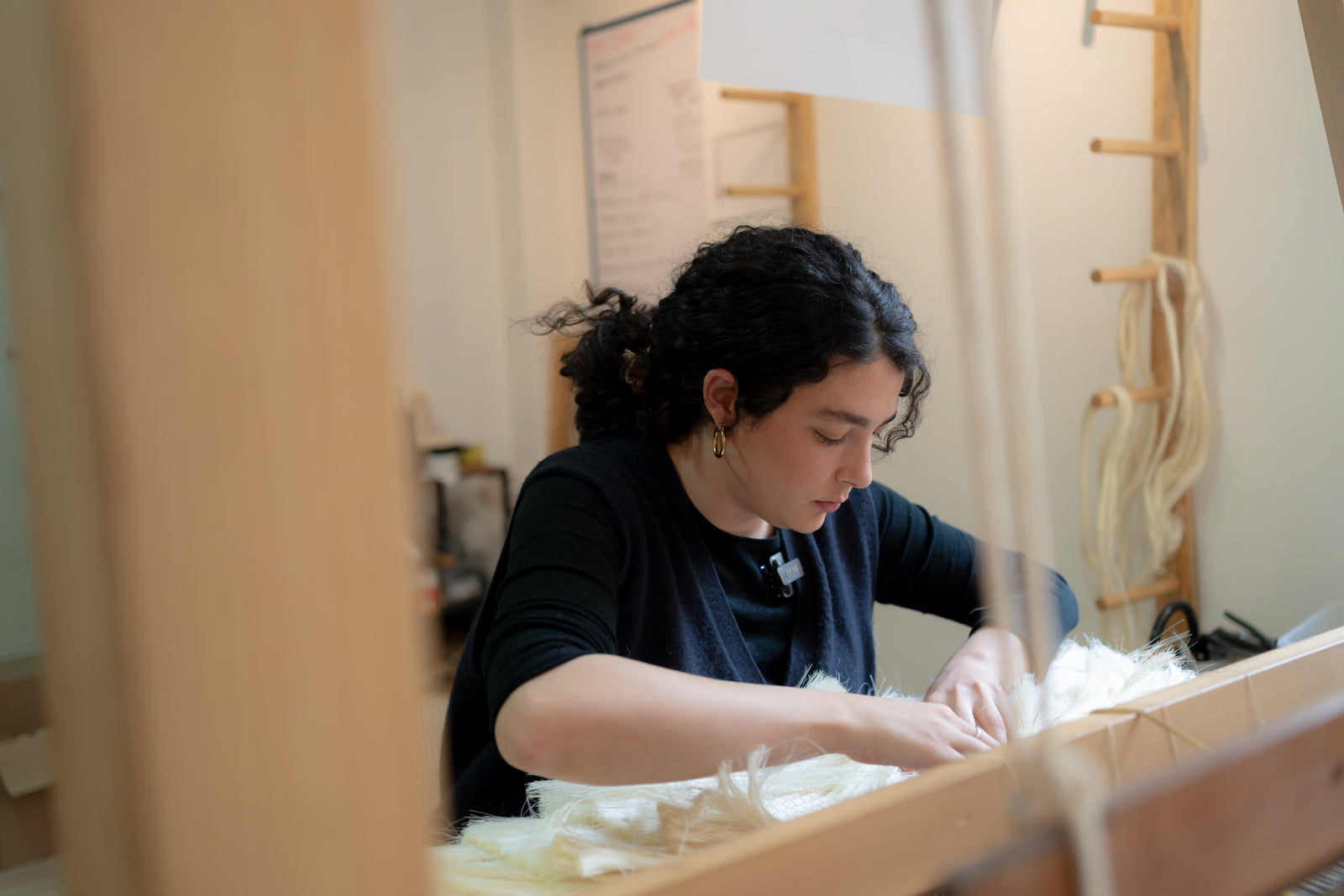Ana, Kreye Studio founder, working on a craft project in a workshop setting
