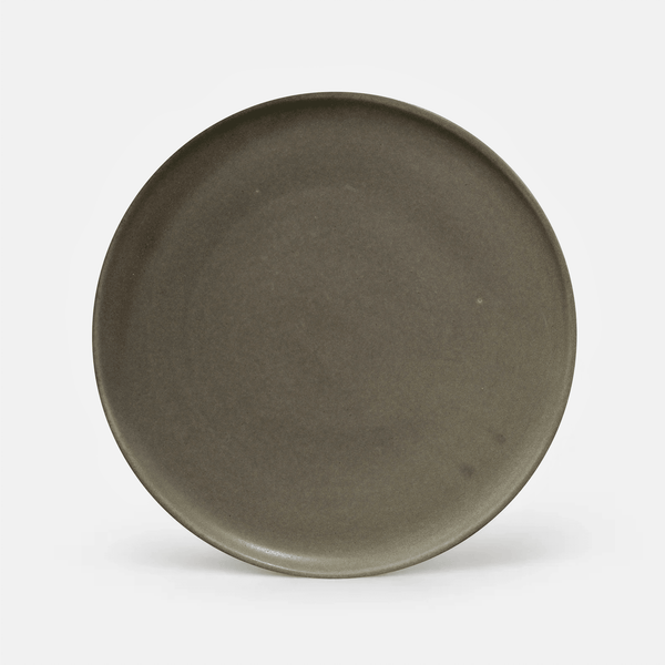 A round ceramic plate with a matte, dark olive-brown glaze, photographed from directly above on a clean white background.