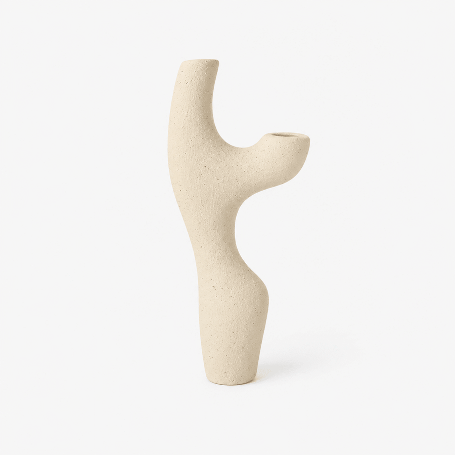 Beige ceramic vase with abstract design on a white background