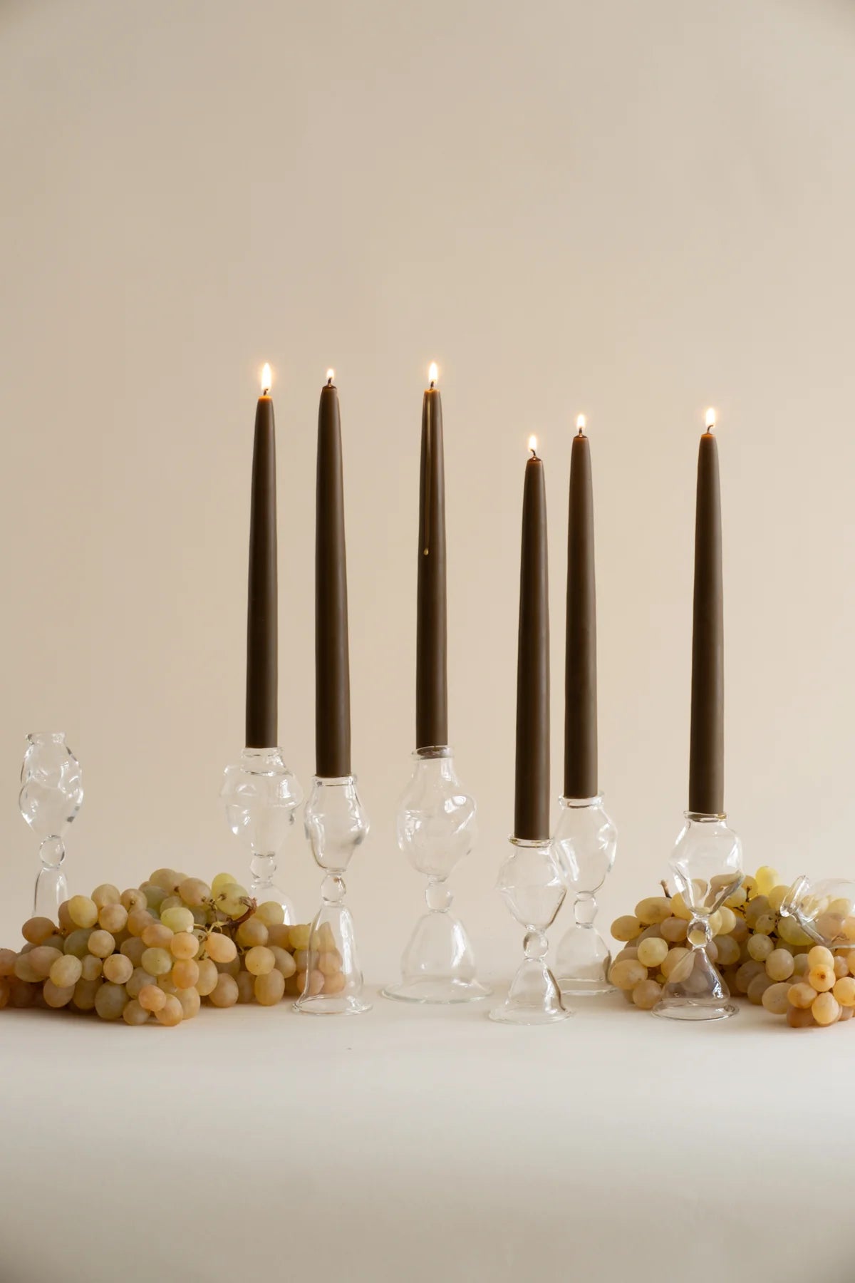 Elegant glass candle holders with taper candles, a premium corporate gift idea for clients and employee gifting