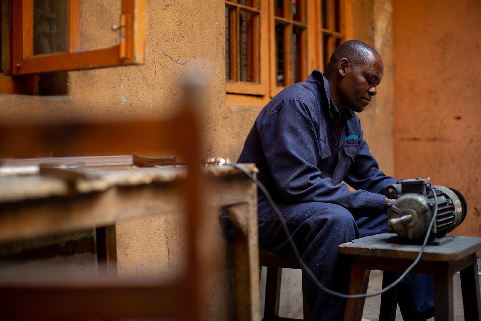 Sylvester making jewelry in his workshop.