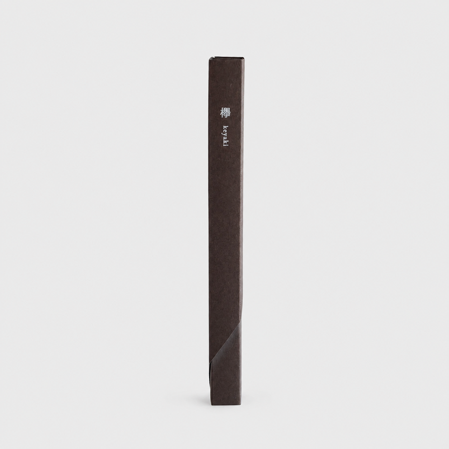 A dark brown textured incense box standing vertically on a light gray background, featuring a small white logo and the word 'keyaki' printed near the top.