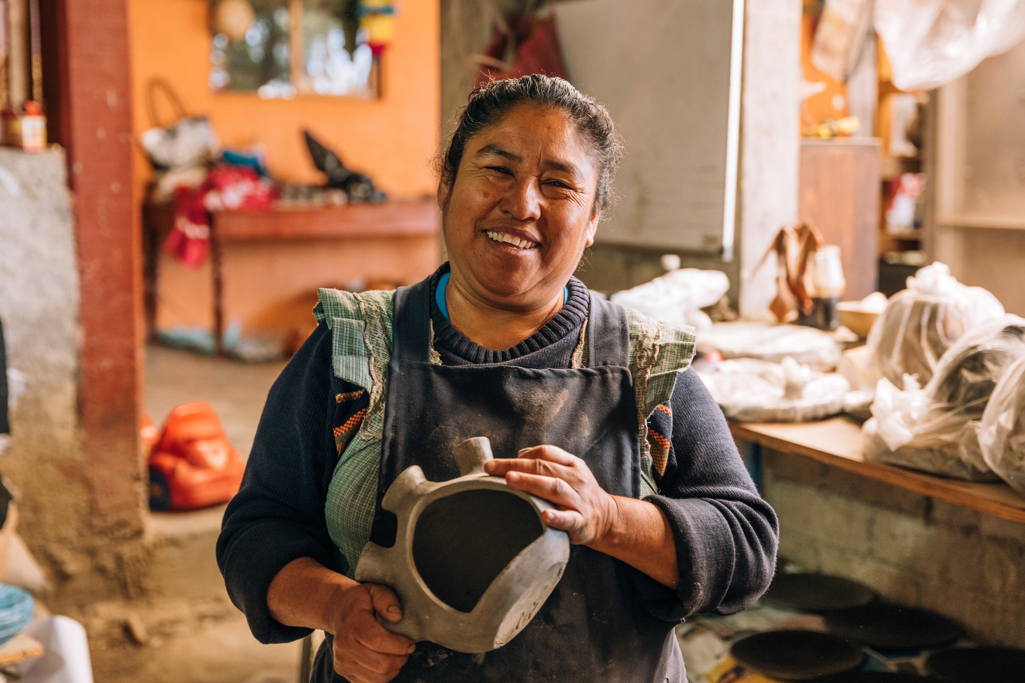 Rufina holding a candle holder/Incense holder.