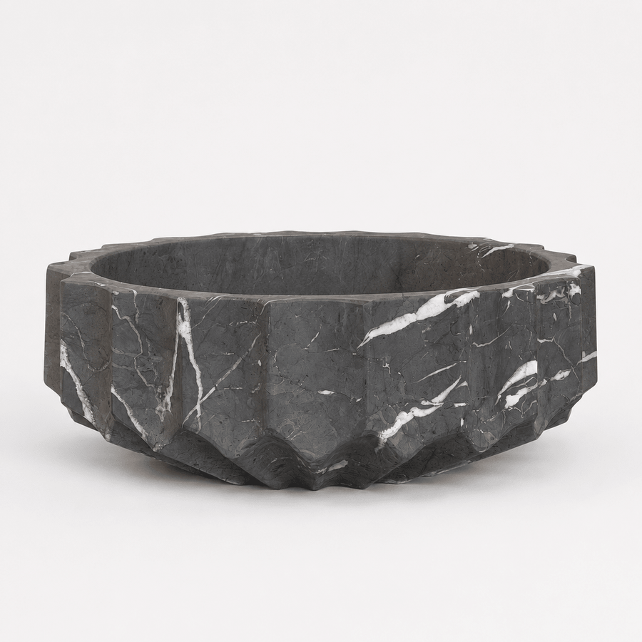 Black marble bowl with a faceted design on a white background