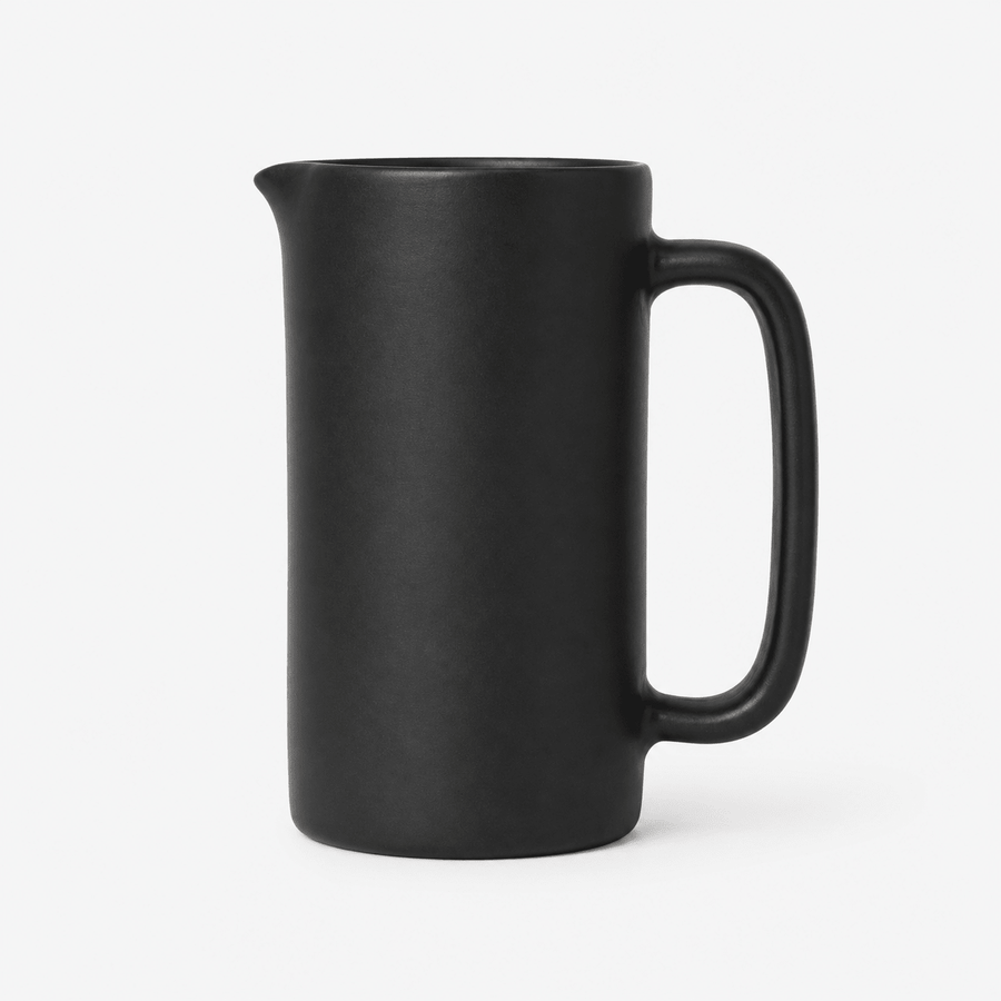 Black ceramic pitcher on a white background