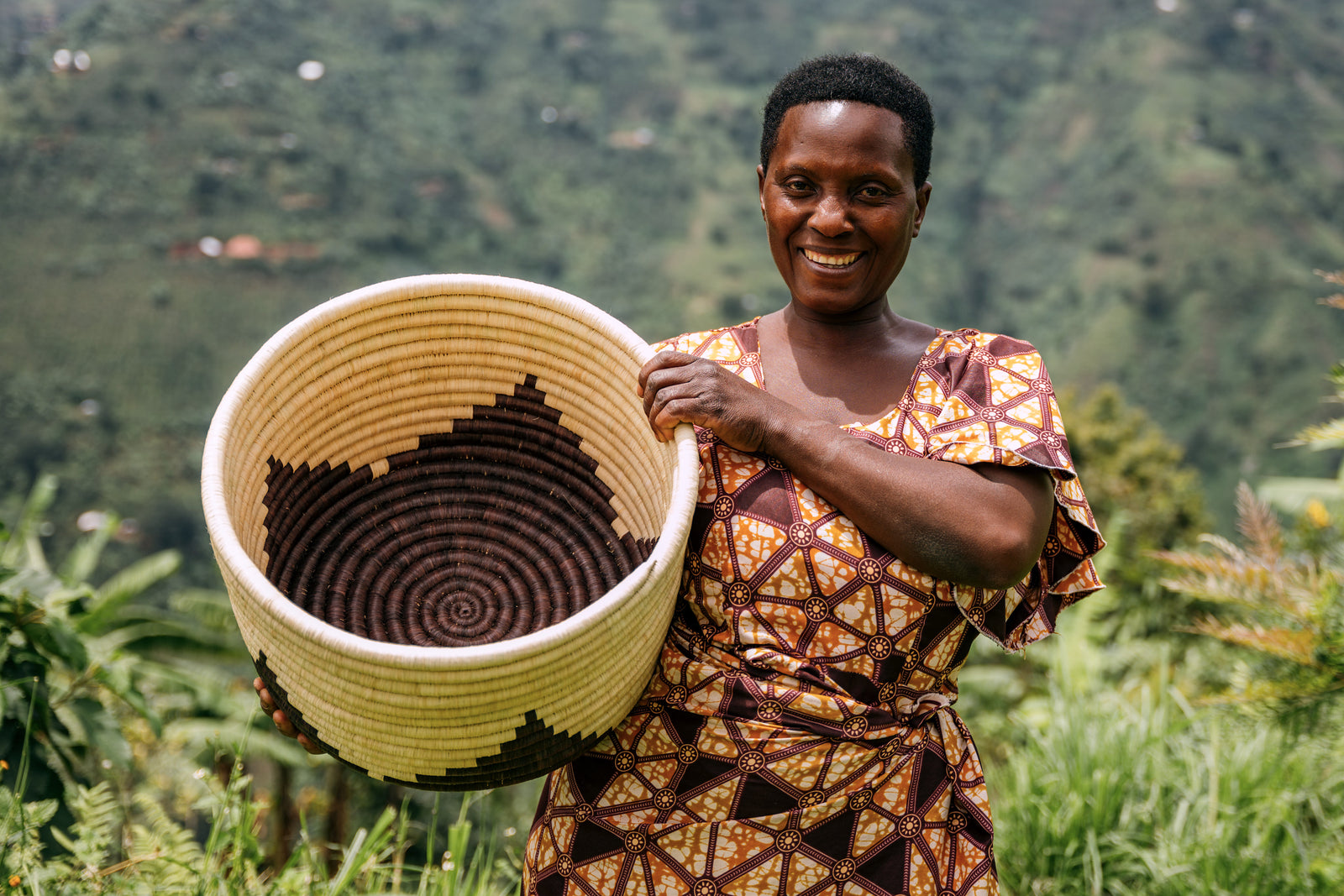 A woman from the village of Kasese holding a basket.