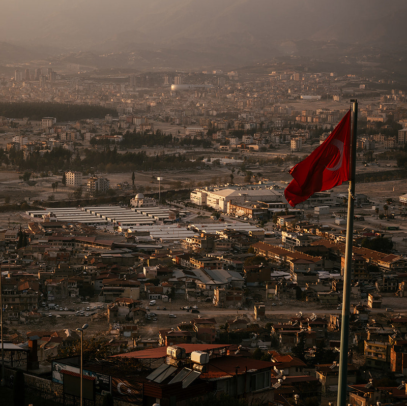 Cityscape with a red flag waving in the foreground