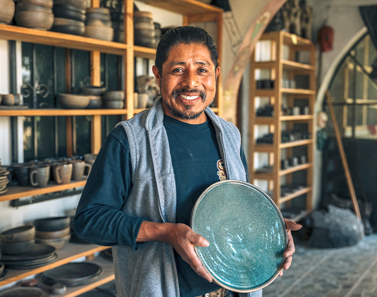 Francisco holding a plate he made.