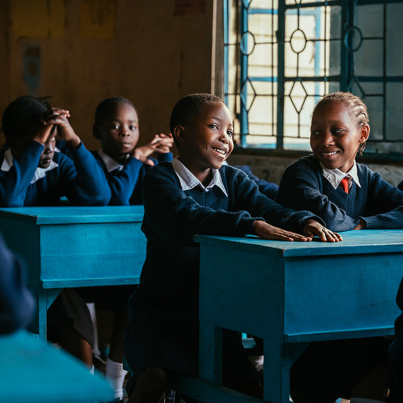 Children in school laughing and smiling.