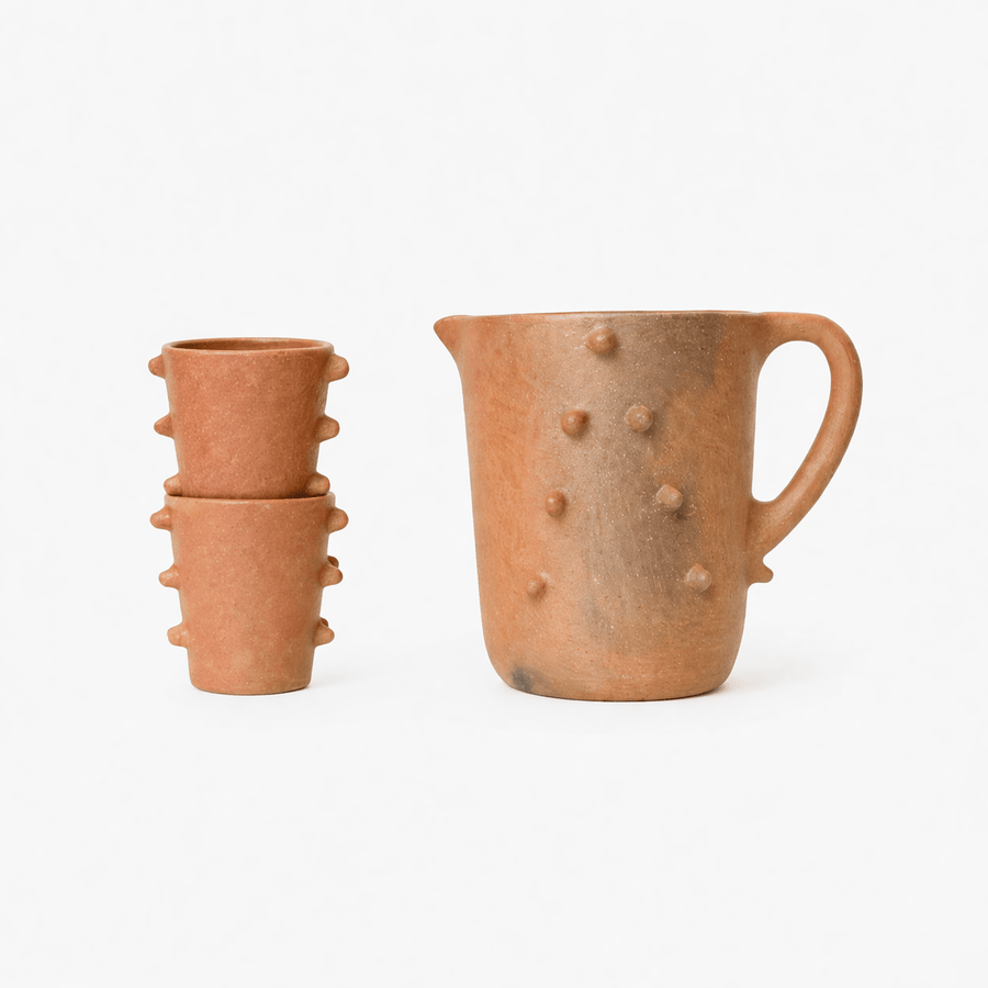 Set of terracotta ceramic pots with textured surface on a white background